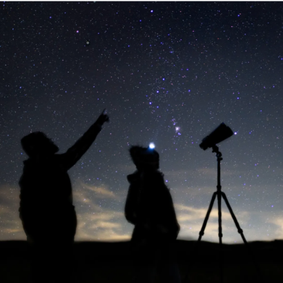 Silhouettes of people with telescopes